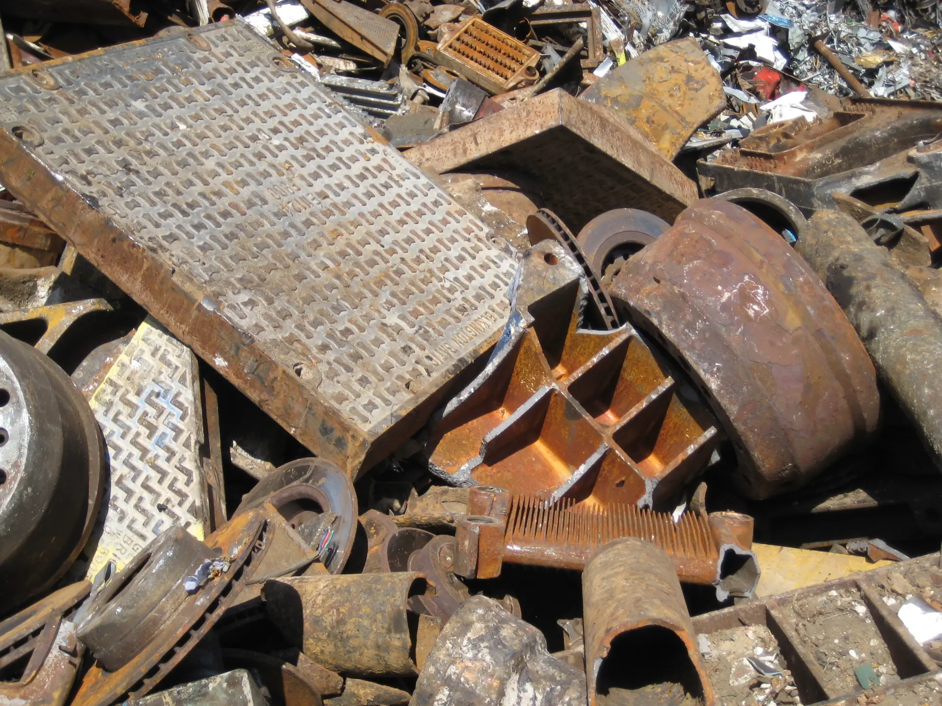 Heavy steel and cast iron pieces in a scrap yard